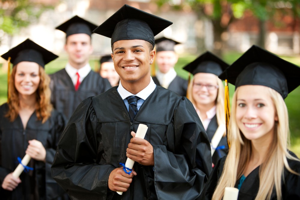 Extensive series of a multi-ethnic group of high school or college students after a graduation ceremony. Candid and posed images, some with diplomas.